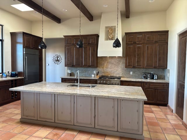 Spacious kitchen with large island and dark cabinets