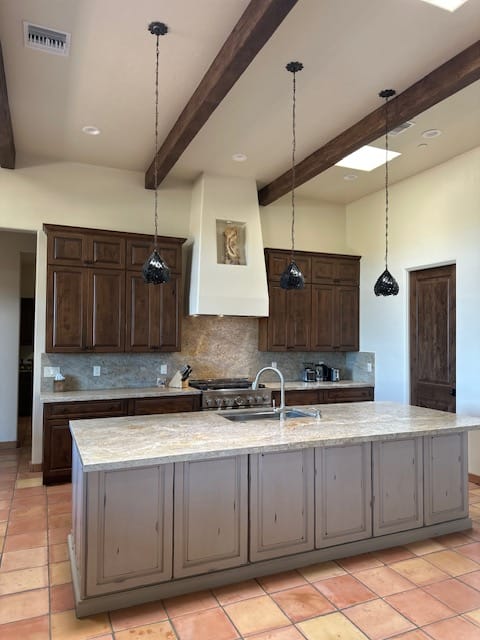 Rustic kitchen with large island and pendant lights